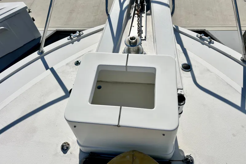 Slide: The Image of Bow deck of 1982 Bertram 46 Convertible yacht with anchor chain and storage compartment. - 23