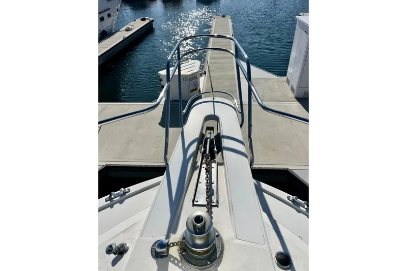 Slide: The Image of Bow view of 1982 Bertram 46 Convertible yacht docked at marina. - 24