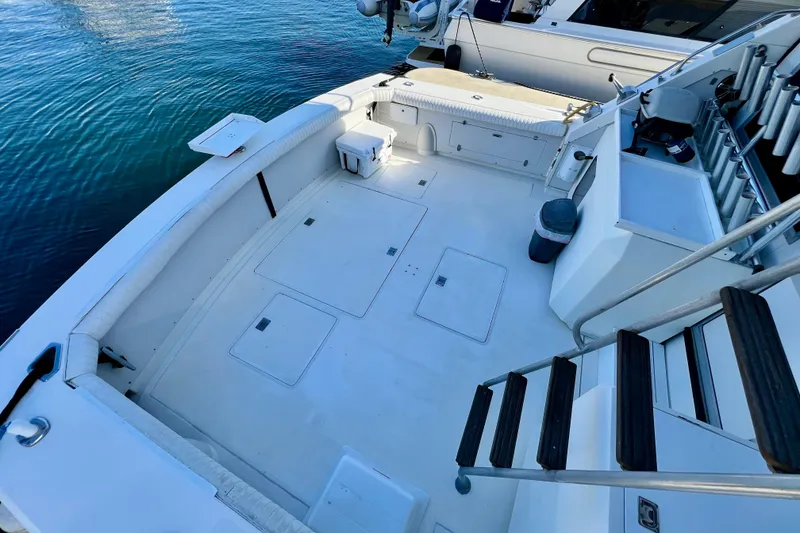 Slide: The Image of 1982 Bertram 46 Convertible yacht deck with seating, storage, and water view. - 29