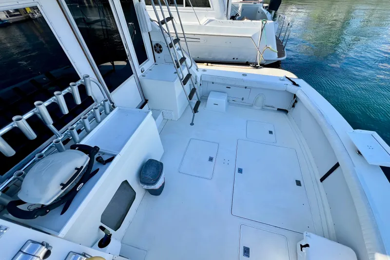 Slide: The Image of 1982 Bertram 46 Convertible boat deck with fishing rod holders and ladder. - 30