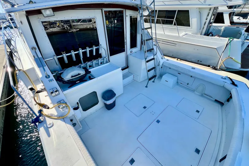 Slide: The Image of 1982 Bertram 46 Convertible yacht deck with fishing rod holders and ladder. - 31