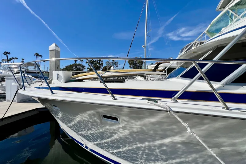 Slide: The Image of 1982 Bertram 46 Convertible yacht docked under clear blue sky. - 4