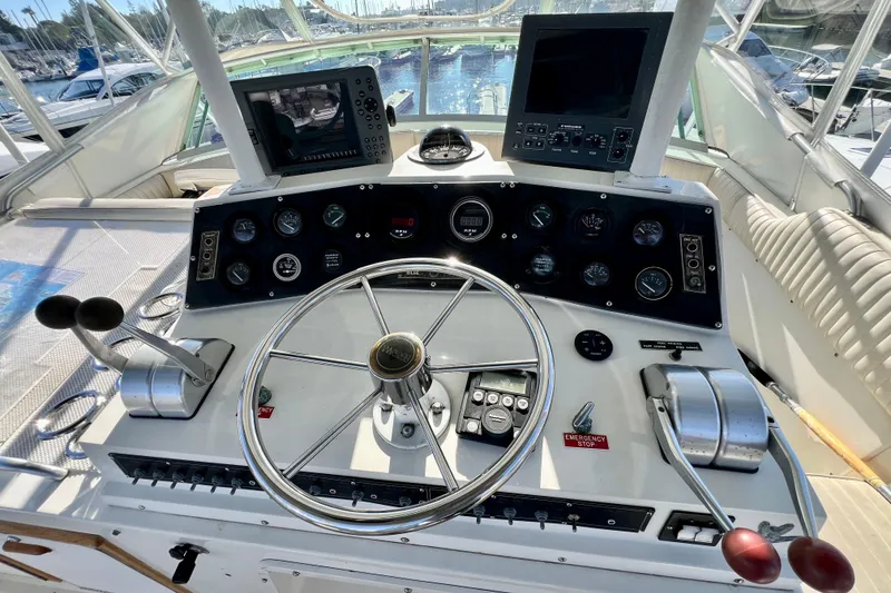 Slide: The Image of 1982 Bertram 46 Convertible yacht helm with dual controls and navigation screens. - 40