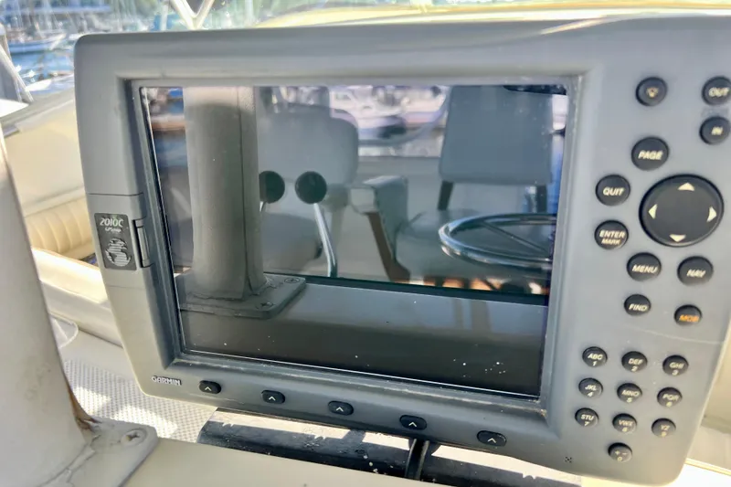 Slide: The Image of Garmin GPS device on 1982 Bertram 46 Convertible yacht dashboard. - 41