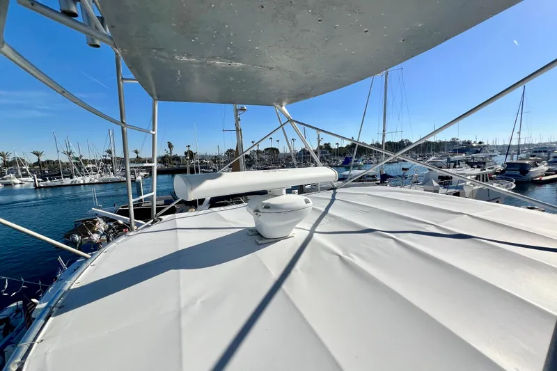 Slide: The Image of 1982 Bertram 46 Convertible yacht at marina, sunny day, clear blue sky. - 48