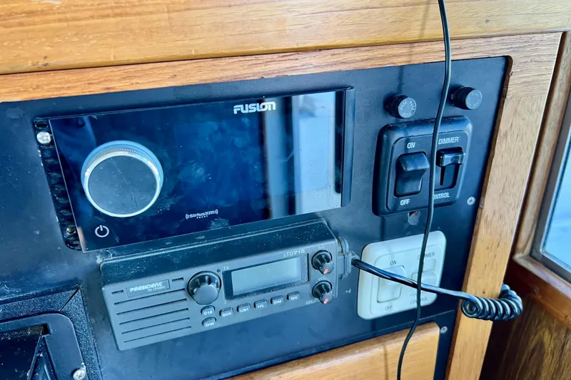 Slide: The Image of Control panel of a 1982 Bertram 46 Convertible boat with radio and switches. - 59