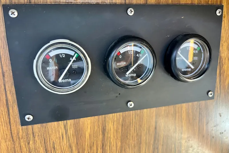 Slide: The Image of Water level gauges on 1982 Bertram 46 Convertible boat dashboard. - 64