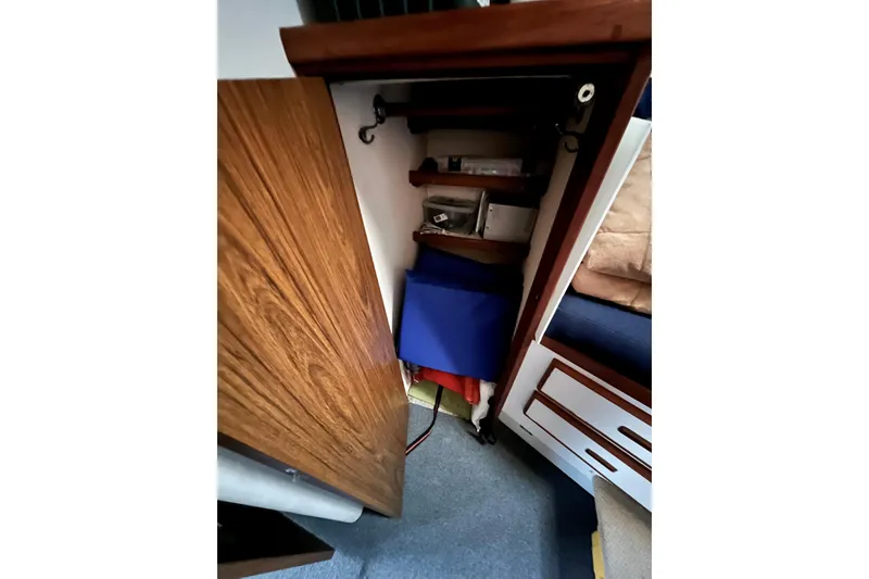 Slide: The Image of Interior storage of 1982 Bertram 46 Convertible boat with wooden cabinet and shelves. - 70
