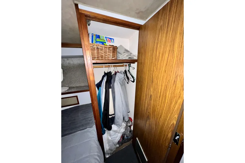 Slide: The Image of Closet interior on 1982 Bertram 46 Convertible yacht with hanging clothes and storage basket. - 72