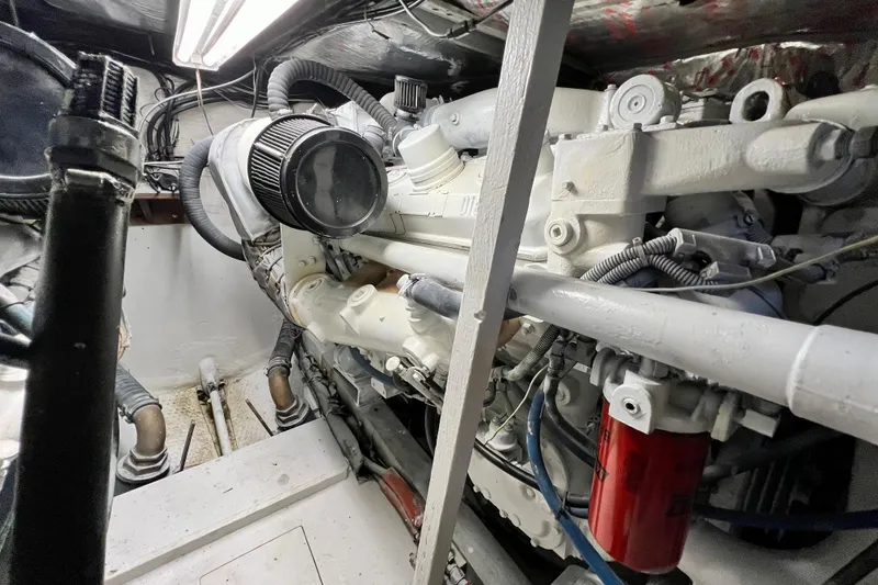 Slide: The Image of Engine room of a 1982 Bertram 46 Convertible yacht, showcasing mechanical components. - 76