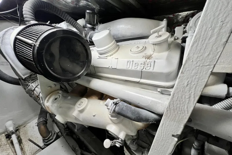 Slide: The Image of 1982 Bertram 46 Convertible diesel engine, detailed view of components and hoses. - 77