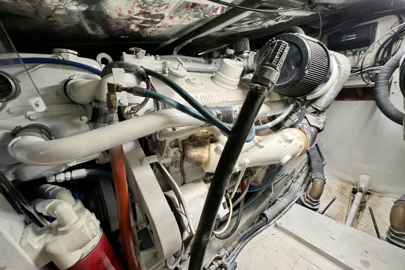 Slide: The Image of Engine room of a 1982 Bertram 46 Convertible boat, showcasing detailed machinery. - 78