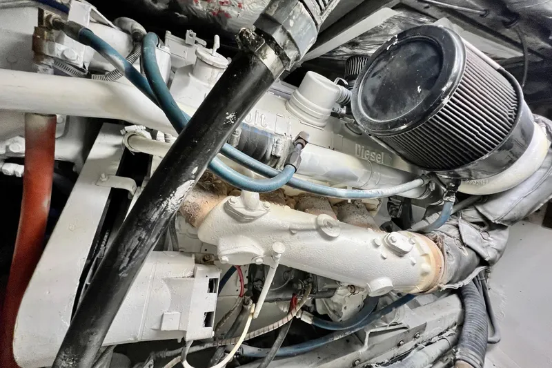 Slide: The Image of Engine of 1982 Bertram 46 Convertible boat, showcasing diesel components and hoses. - 79