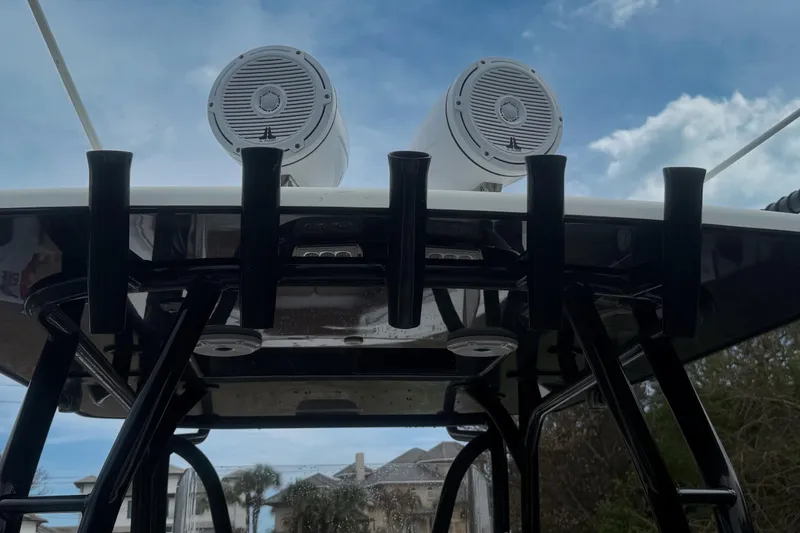 Slide: The Image of 2018 Yellowfin 36 Offshore boat with T-top and rod holders against blue sky. - 10