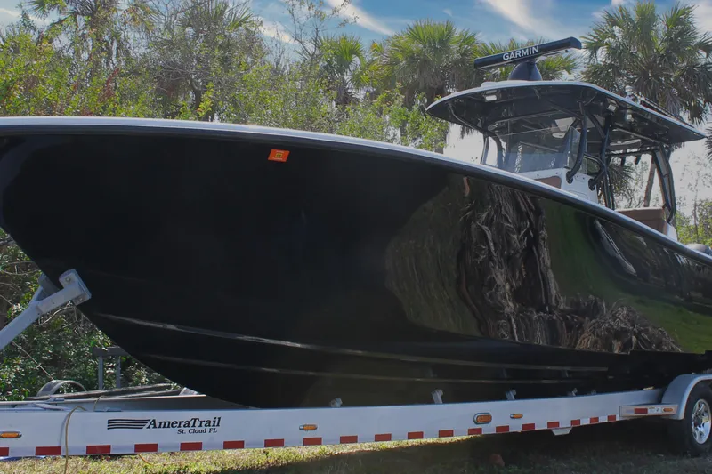 Slide: The Image of 2018 Yellowfin 36 Offshore boat on trailer, surrounded by trees. - 20