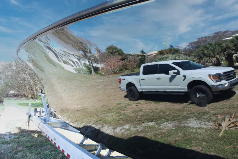 Slide: The Image of Reflection of a white truck on a 2018 Yellowfin 36 Offshore boat hull. - 21