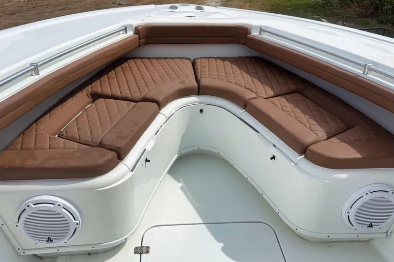 Slide: The Image of 2018 Yellowfin 36 Offshore boat interior with brown cushioned seating and white deck. - 3