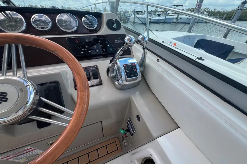 Slide: The Image of 2005 Sea Ray Sundancer 350 helm with wooden steering wheel and control panel. - 15