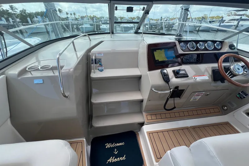 Slide: The Image of 2005 Sea Ray Sundancer 350 helm with navigation equipment and welcome mat. - 16