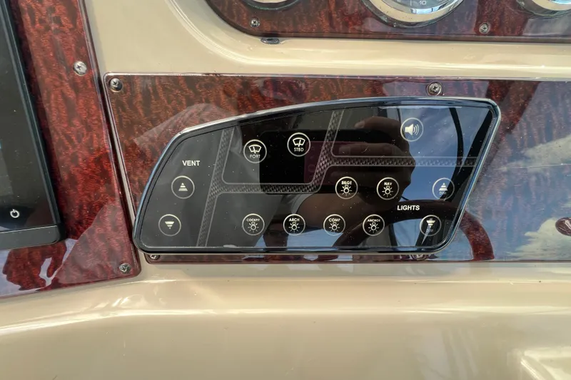 Slide: The Image of Control panel of a 2005 Sea Ray Sundancer 350 boat with various switches. - 18
