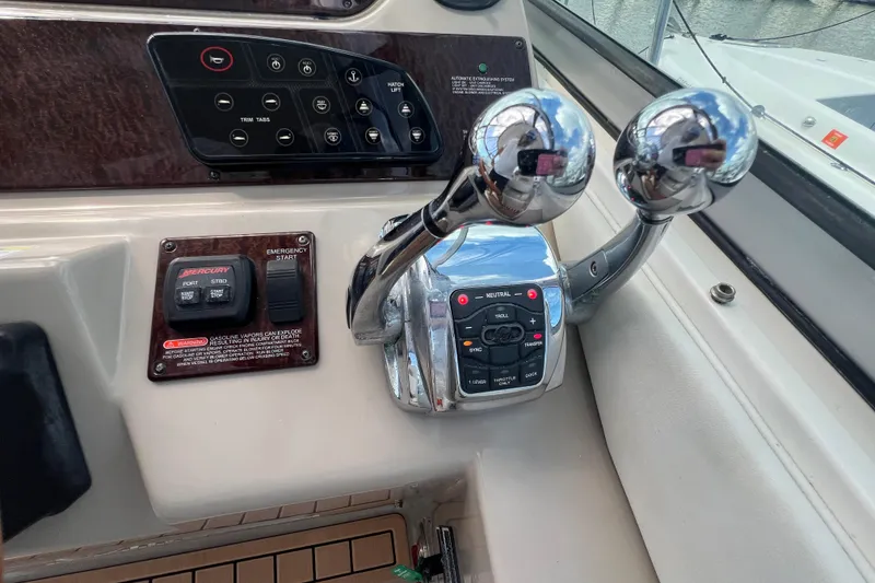 Slide: The Image of Control panel of a 2005 Sea Ray Sundancer 350 boat with throttle levers and switches. - 20