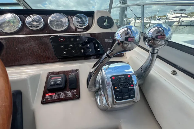 Slide: The Image of Control panel of a 2005 Sea Ray Sundancer 350 boat with throttle levers. - 21