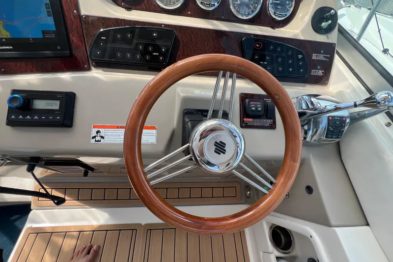 Slide: The Image of Steering wheel and controls of a 2005 Sea Ray Sundancer 350 boat cockpit. - 22