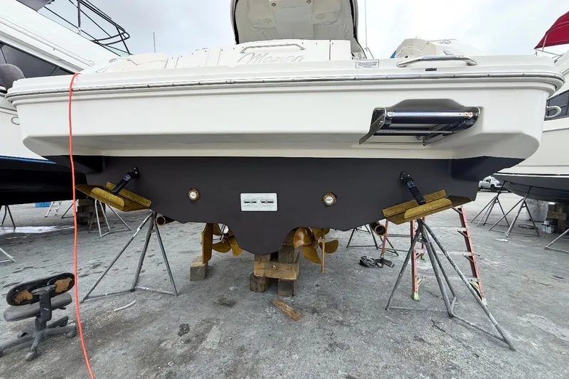Slide: The Image of 2009 Sea Ray Sundancer 350 boat on stands, showing hull and propellers. - 49