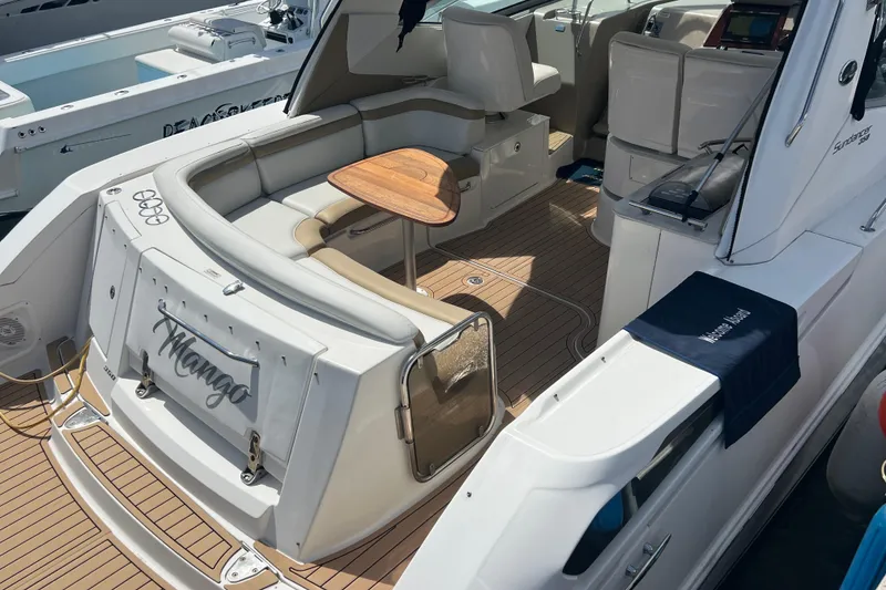 Slide: The Image of 2005 Sea Ray Sundancer 350 yacht with spacious seating and elegant wooden table. - 3