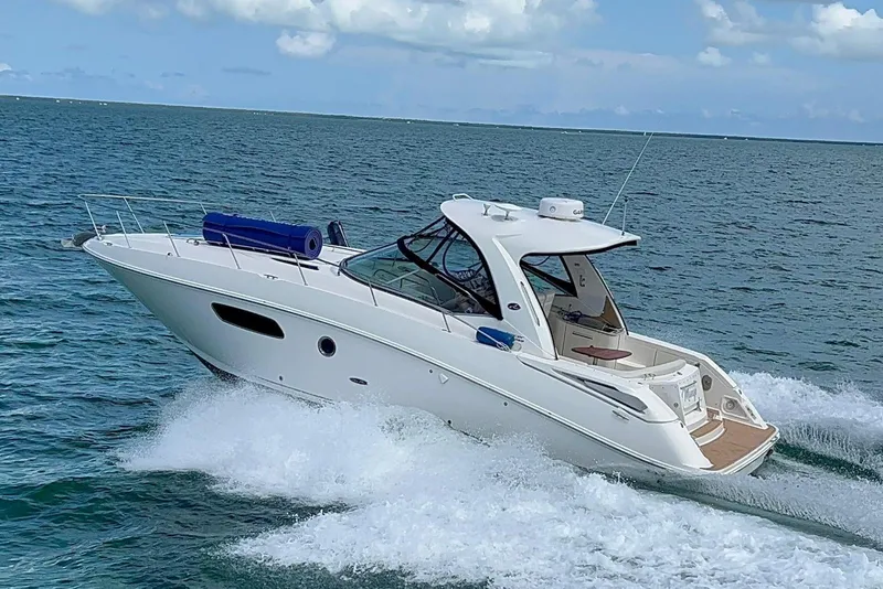 Slide: The Image of 2009 Sea Ray Sundancer 350 cruising on open water under a clear sky. - 31