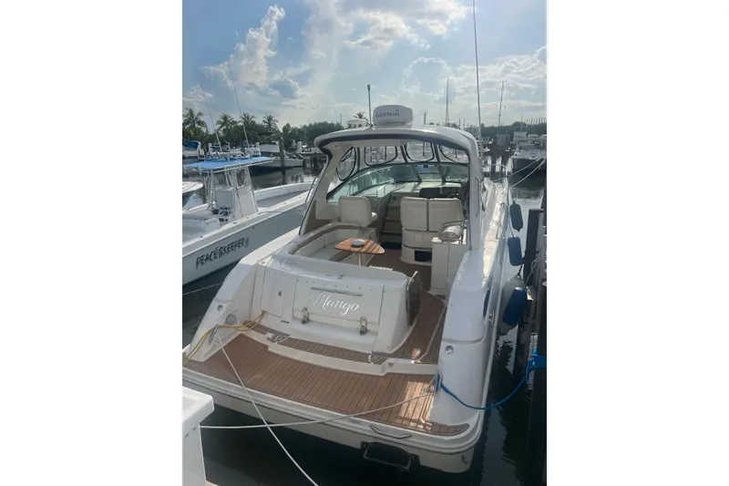 Slide: The Image of 2009 Sea Ray Sundancer 350 docked at marina under a partly cloudy sky. - 32