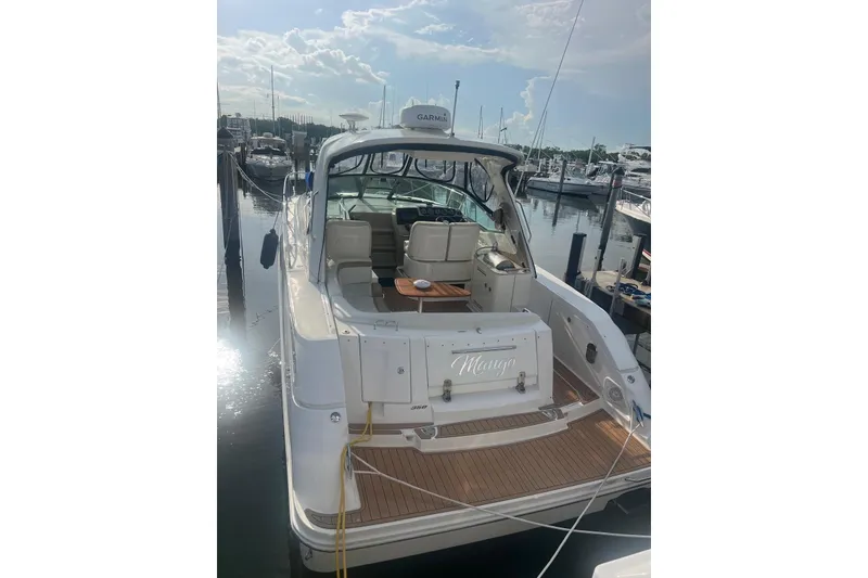 Slide: The Image of 2009 Sea Ray Sundancer 350 docked, showcasing spacious deck and seating area under clear skies. - 33