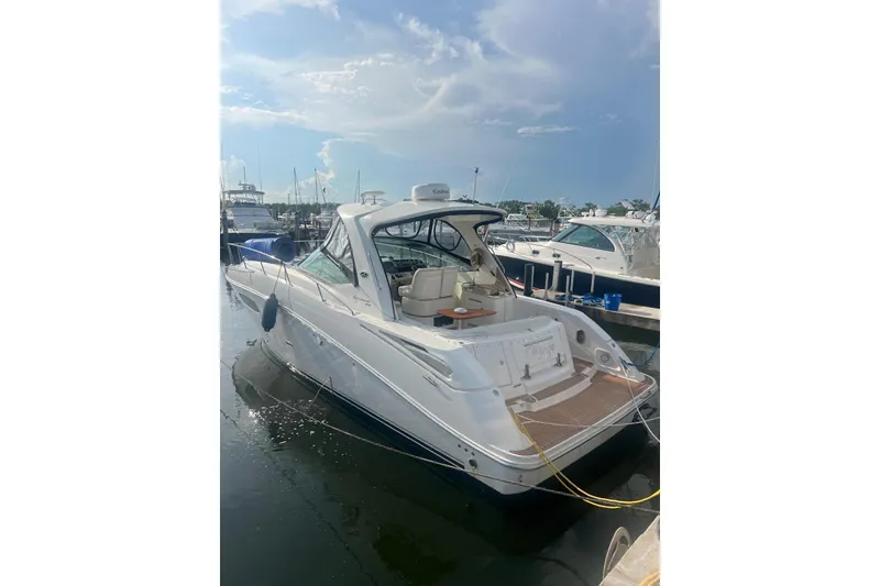 Slide: The Image of 2009 Sea Ray Sundancer 350 yacht docked at marina under clear sky. - 34