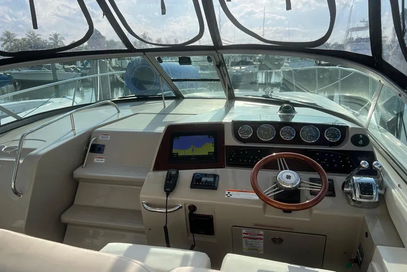 Slide: The Image of 2009 Sea Ray Sundancer 350 helm with steering wheel, gauges, and navigation system. - 36