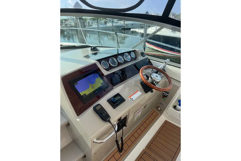Slide: The Image of Helm of 2009 Sea Ray Sundancer 350 with navigation display and wooden steering wheel. - 37