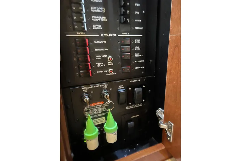 Slide: The Image of Control panel of a 2009 Sea Ray Sundancer 350 boat, featuring switches and ignition keys. - 39
