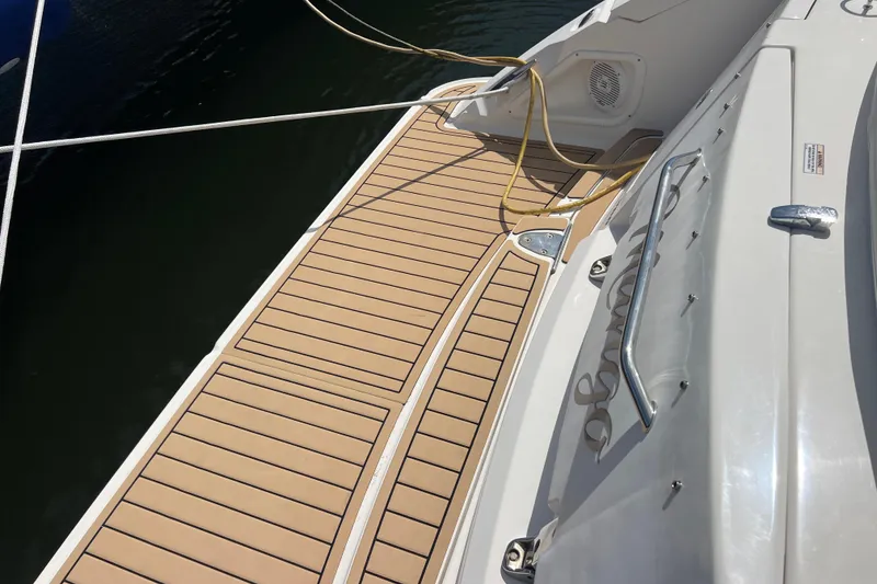 Slide: The Image of 2005 Sea Ray Sundancer 350 boat deck with teak flooring and mooring lines. - 4