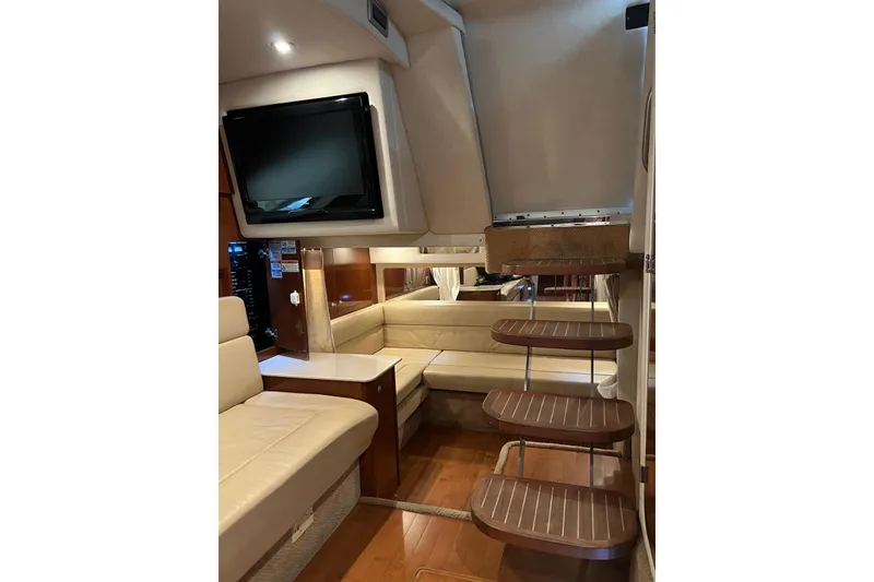 Slide: The Image of Interior of 2009 Sea Ray Sundancer 350 yacht with seating, TV, and wooden steps. - 41