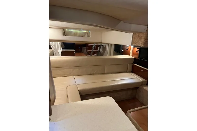 Slide: The Image of 2009 Sea Ray Sundancer 350 interior with beige seating and wooden accents. - 42