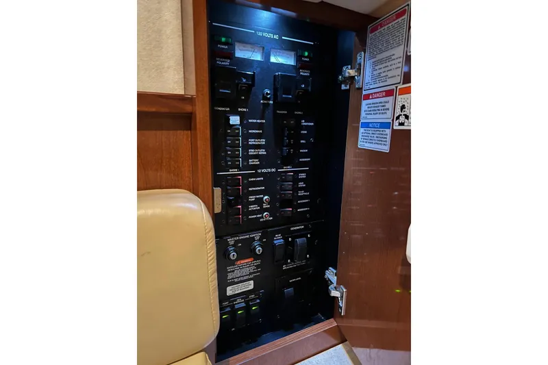 Slide: The Image of Electrical panel inside 2009 Sea Ray Sundancer 350 boat, featuring various switches and controls. - 43
