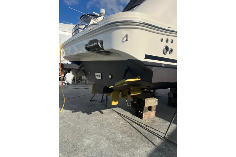 Slide: The Image of 2009 Sea Ray Sundancer 350 yacht on blocks, showcasing rear view and propellers. - 46