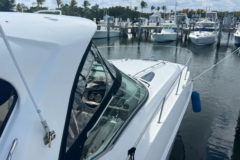 Slide: The Image of 2005 Sea Ray Sundancer 350 docked at marina with other boats in background. - 5