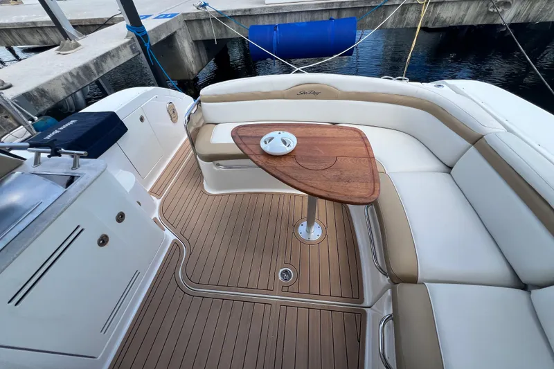Slide: The Image of 2005 Sea Ray Sundancer 350 boat interior with teak deck and cushioned seating. - 9