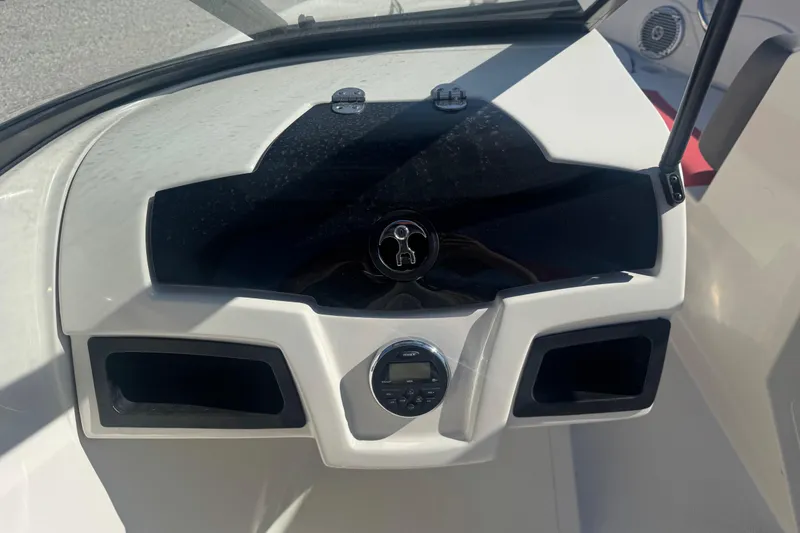 Slide: The Image of Dashboard of a 2016 Tahoe 500 TF boat with stereo system and storage compartments. - 12