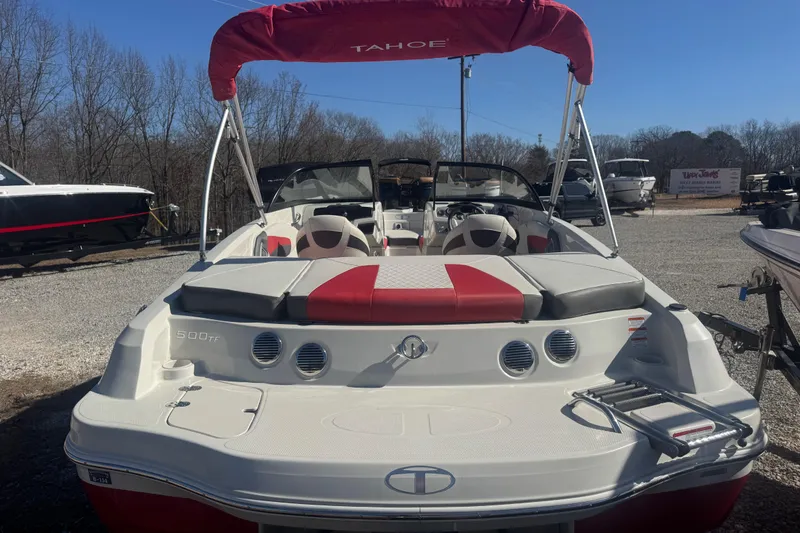 Slide: The Image of 2016 Tahoe 500 TF boat with red and white seating, parked outdoors. - 4