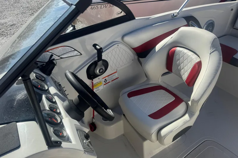 Slide: The Image of Interior of a 2016 Tahoe 500 TF boat with steering wheel and cushioned seat. - 9