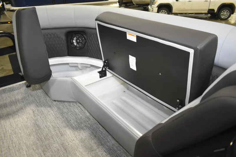 Slide: The Image of 2026 Premier 230 Sunsation RL boat interior with open storage compartment and speaker. - 19