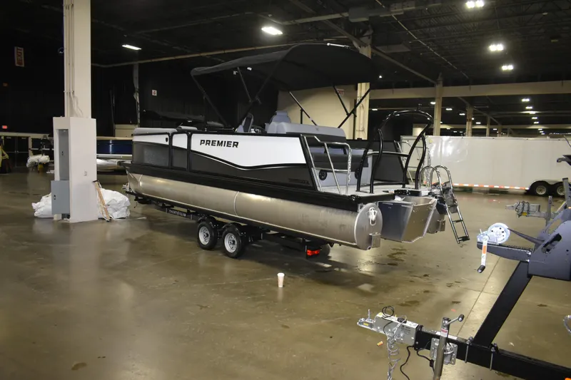 Slide: The Image of 2026 Premier 230 Sunsation RL - PTX CL pontoon boat displayed indoors on a trailer. - 3