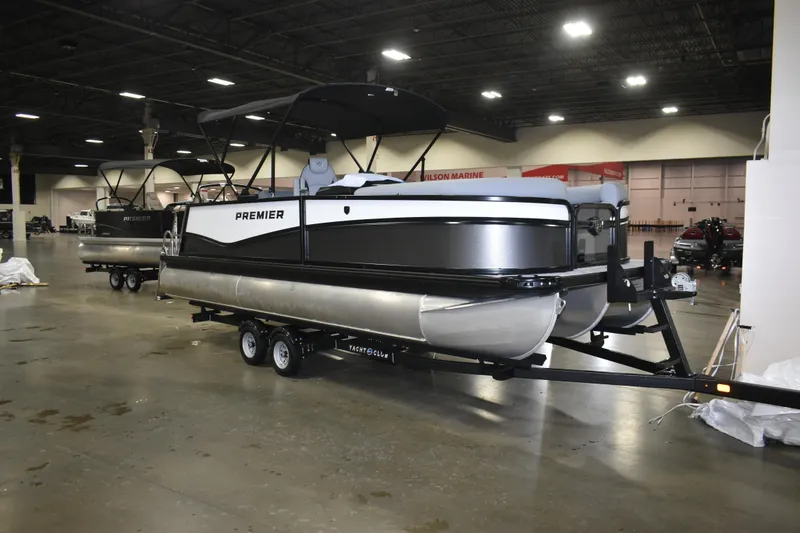 Slide: The Image of 2026 Premier 230 Sunsation RL pontoon boat on trailer in indoor showroom. - 4