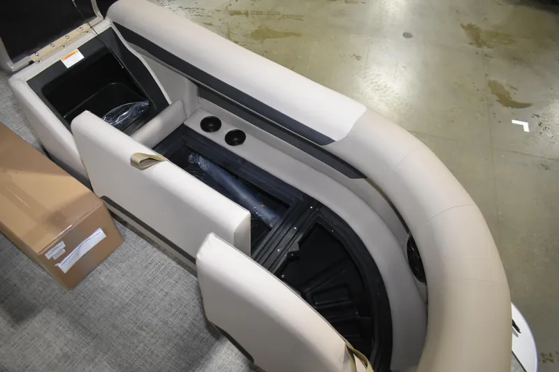 Slide: The Image of 2026 Premier 220 Sunscape RF - CL boat interior with beige seating and storage compartments. - 14